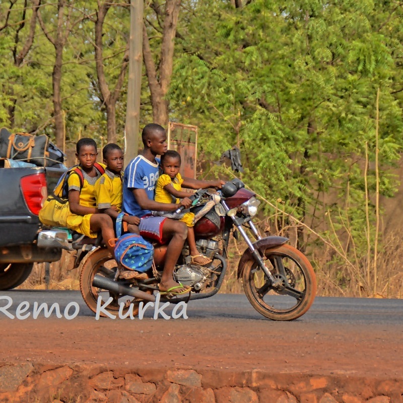 Dad with 3 kids on a motorbike, Ghana, Northern region